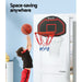 Boy taking jump shot on Everfit 38 Inch baksetball ring mounting on a door inside a room
