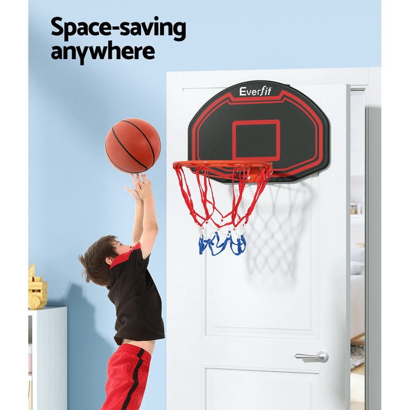 Boy taking jump shot on Everfit 38 Inch baksetball ring mounting on a door inside a room